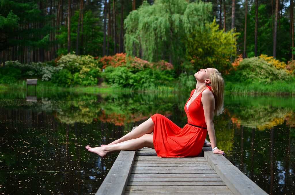 Woman in red near lake