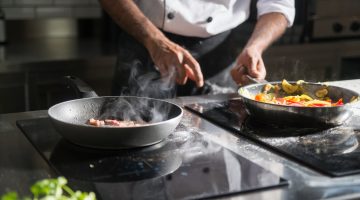 Chef in kitchen with wok