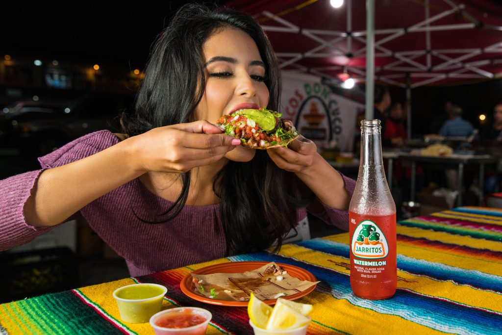 Woman eating a Tostada
