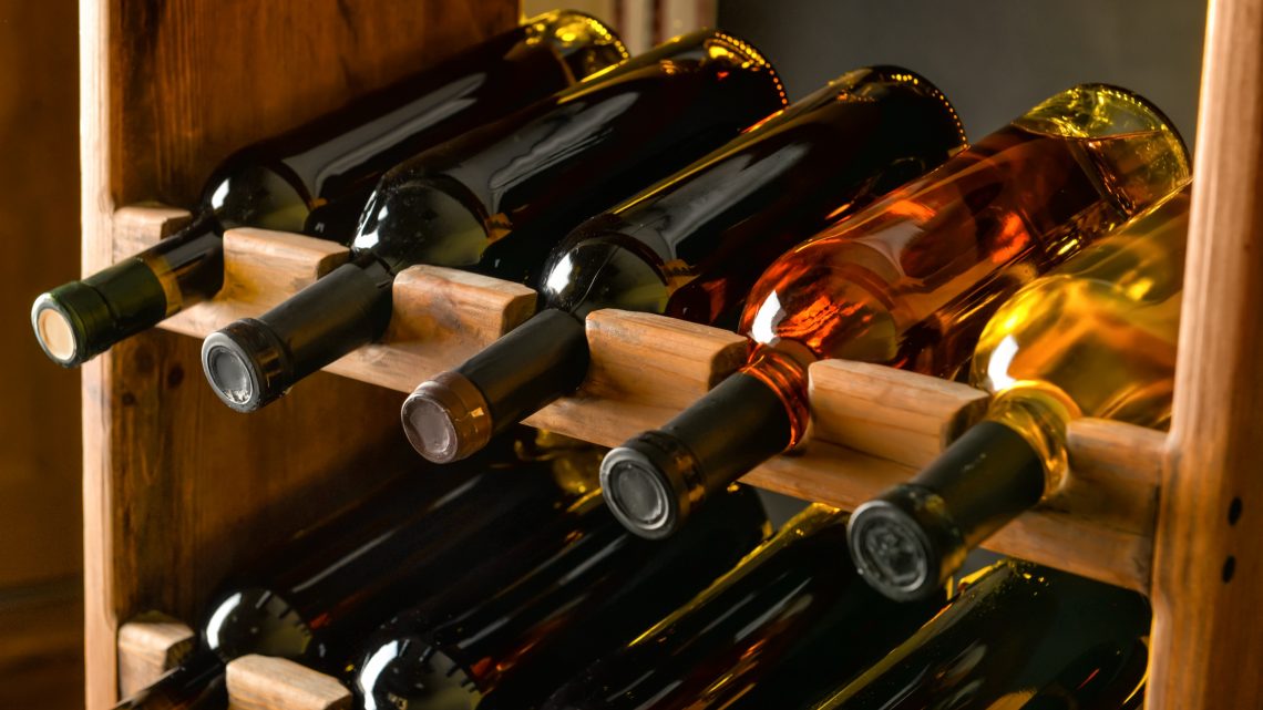 A wine rack with 9 bottles of wine