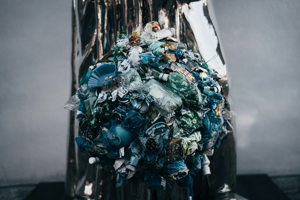 A creative sculpture made from compacted plastic waste, highlighting the importance of recycling and sustainable waste management practices.