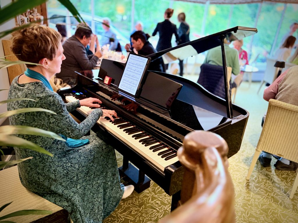Live pianist performing during evening service at Bettys, enhancing the refined dining atmosphere with soft classical music.