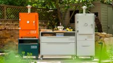 Charlie Charcoal Oven in a modern outdoor kitchen, premium black powder-coated finish with chimney, showcasing durable design for grilling, roasting, baking and smoking.