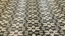 Patterned black, grey, and white hexagonal tile flooring arranged in a star-shaped geometric design, creating a stylish and modern surface suitable for contemporary interiors.