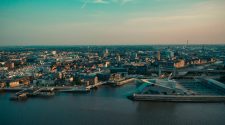 Aerial view of Hull’s waterfront at sunset, showing the city skyline, marina, bridges and The Deep aquarium beside the River Humber.