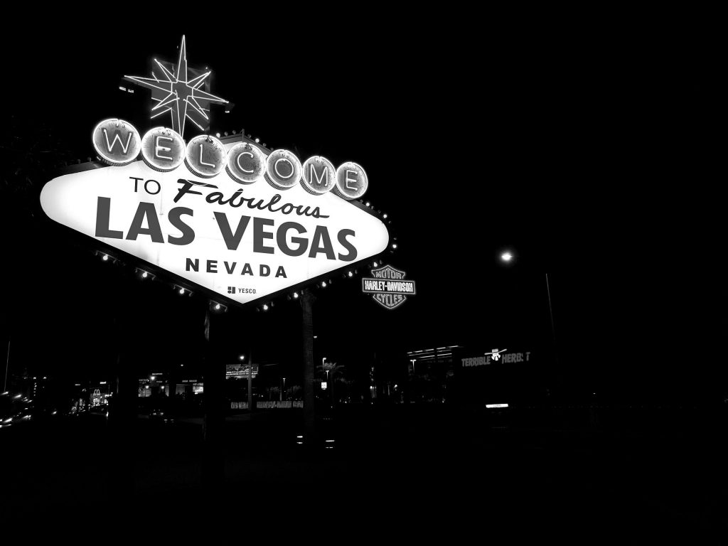 Iconic Welcome to Fabulous Las Vegas Nevada sign illuminated at night in black and white.