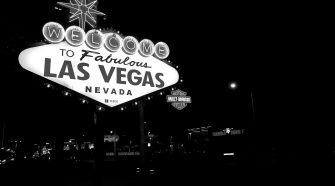 Iconic Welcome to Fabulous Las Vegas Nevada sign illuminated at night in black and white.