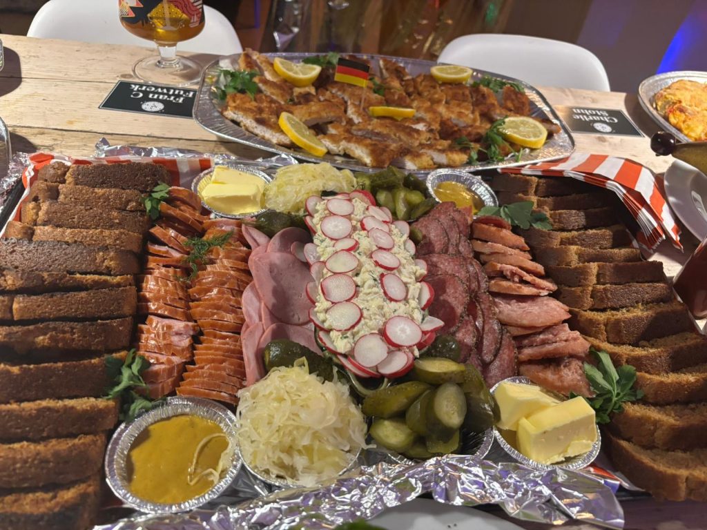 Polish rye bread served with smoked meats, radishes, pickles and mustard on a traditional platter