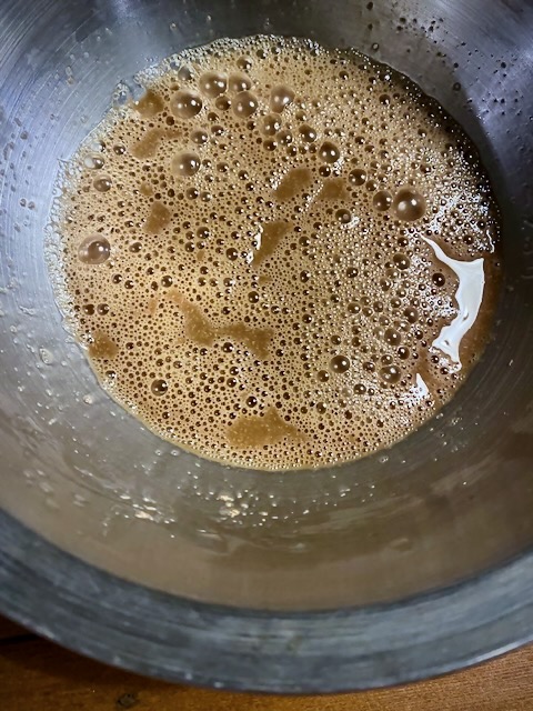 Active rye sourdough starter bubbling in a metal mixing bowl
