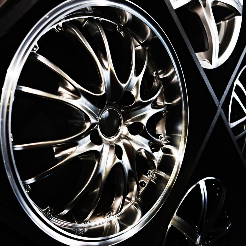 Close-up of polished 18 inch alloy wheels with multi-spoke design on display in showroom