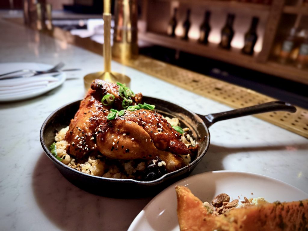 Rotisserie half chicken with shiitake rice, sesame seeds and green chilli served at FOWL restaurant in London