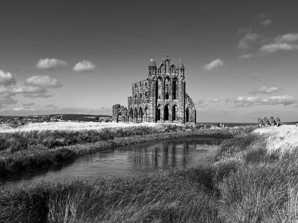 Whitby Abbey ruins overlooking coastal landscape with river and grasslands in North Yorkshire, dramatic historic setting for special occasions