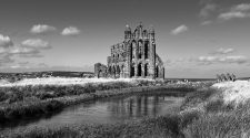 Whitby Abbey ruins overlooking coastal landscape with river and grasslands in North Yorkshire, dramatic historic setting for special occasions