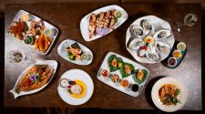 An overhead view of dishes at Sukhothai South Parade in Leeds including oysters, prawns, seafood starters, curry and dessert