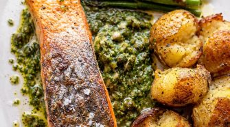 Seared salmon with salsa verde, roasted new potatoes and Tenderstem broccoli – a healthy high-protein salmon dinner recipe with crispy skin salmon and fresh herb sauce.