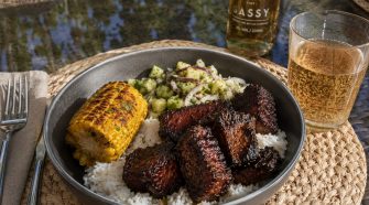Jerk pork belly burnt ends with pineapple chow, coconut rice and rum-glazed corn