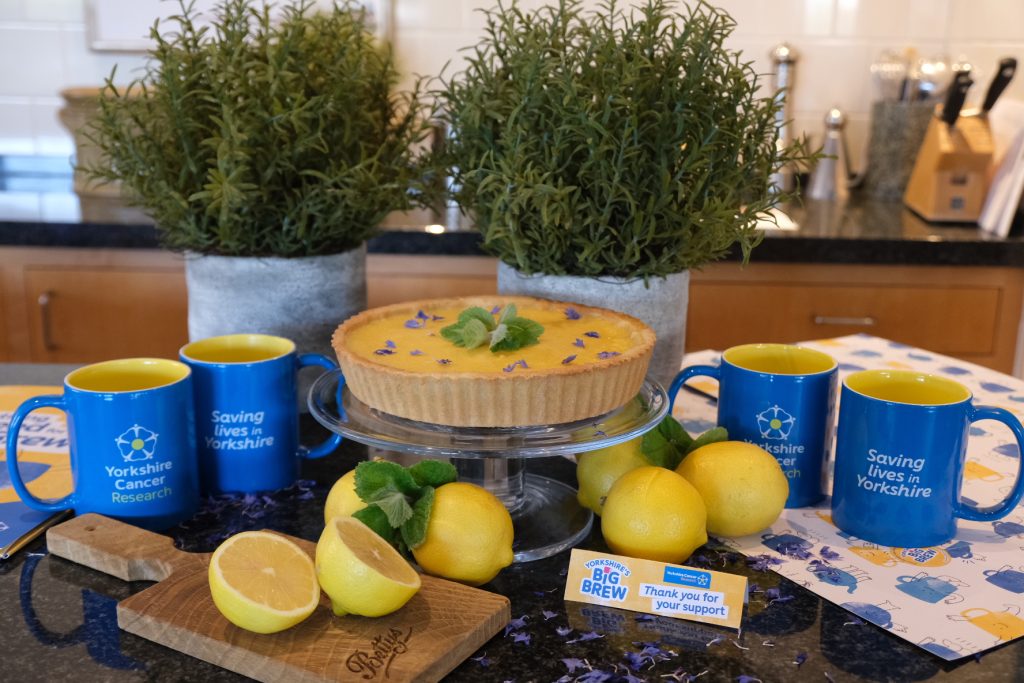 Bettys lemon tart with Yorkshire Cancer Research Big Brew mugs and fresh lemons