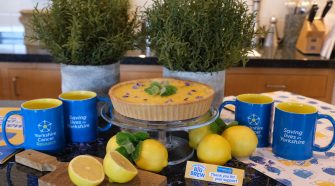 Bettys lemon tart with Yorkshire Cancer Research Big Brew mugs and fresh lemons