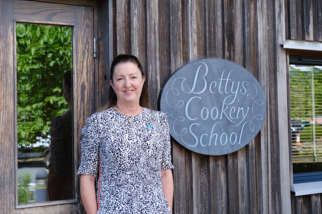Ruth Burke-Kennedy from Bettys supporting Yorkshire Cancer Research outside Bettys Cookery School