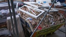 Construction skip filled with renovation rubble and window frames in Leeds