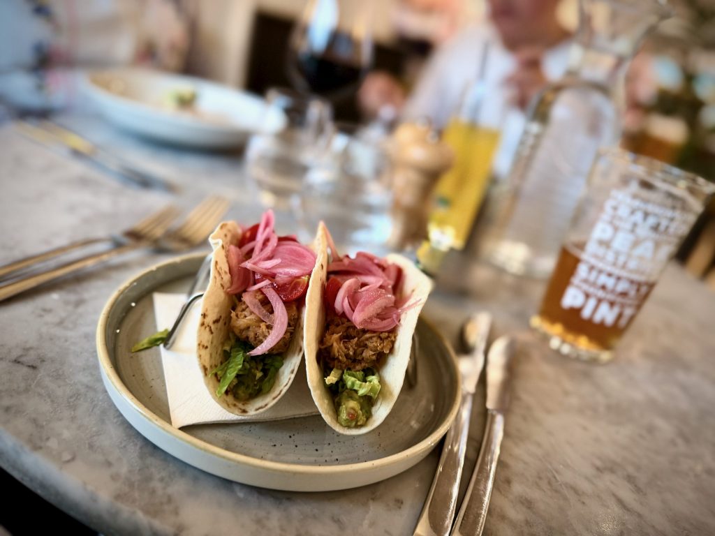 Pulled pork tacos with pink pickled onions, guacamole and cherry tomatoes served at The Devonshire Arms Brasserie, Bolton Abbey.