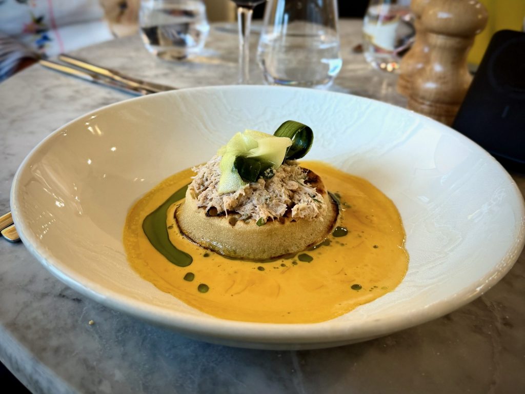 Crab crumpet with pickled cucumber and rich crab bisque served at The Devonshire Arms Brasserie.
