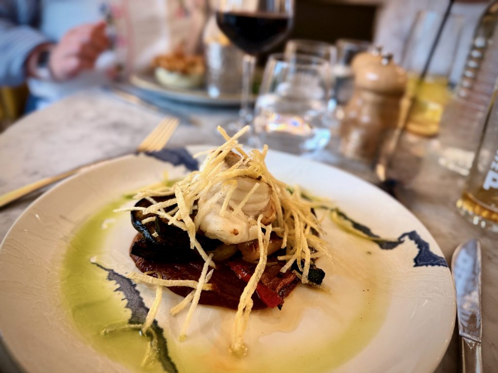 Roast monkfish tail with Mediterranean vegetables, mojo rojo sauce and shoestring fries at The Devonshire Arms Brasserie.