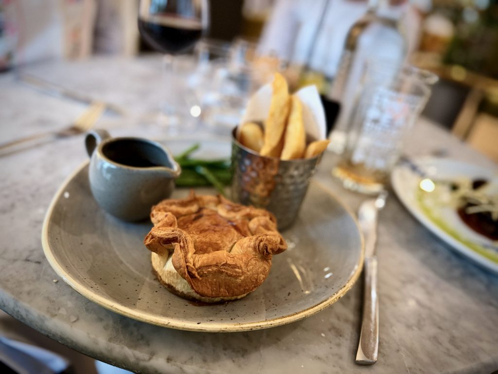 Devonshire beef and mushroom pie with triple cooked chips, gravy and buttered fine beans at The Devonshire Arms Brasserie.