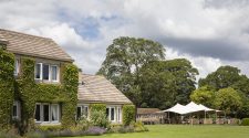 Exterior of The Devonshire Arms Hotel and Spa with landscaped gardens and Brasserie terrace in the Yorkshire Dales.