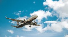 Large aircraft in the blue sky with clouds