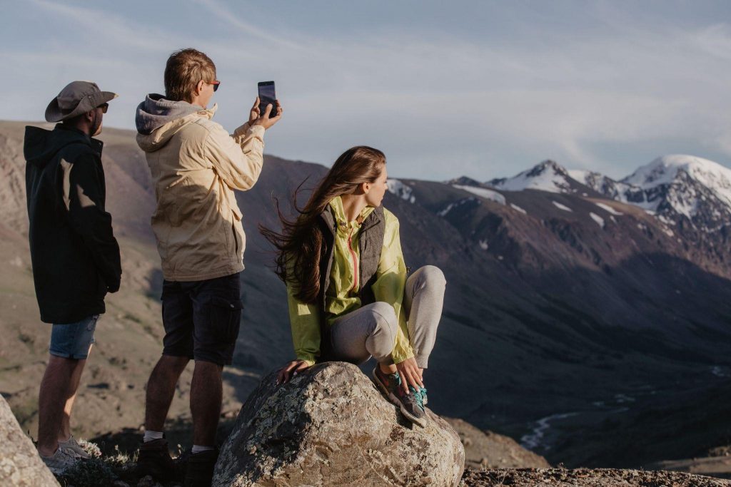 Digital nomads staying social while hiking in the mountains