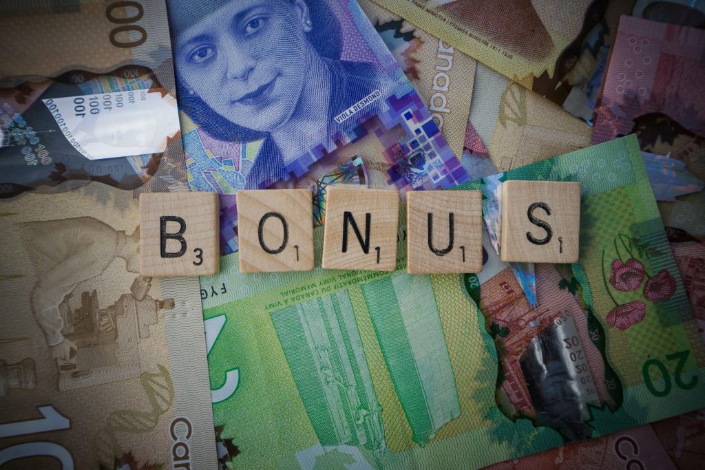 Casino welcome bonuses illustrated with bonus tiles and international banknotes