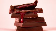 A stack of chocolate with a red cherry filling