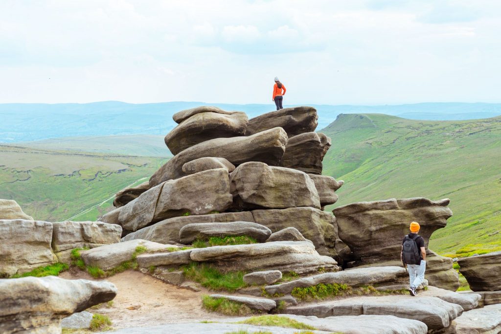 Hikers planning routes across a rocky Yorkshire landscape