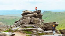 Hikers planning routes across a rocky Yorkshire landscape