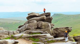 Hikers planning routes across a rocky Yorkshire landscape