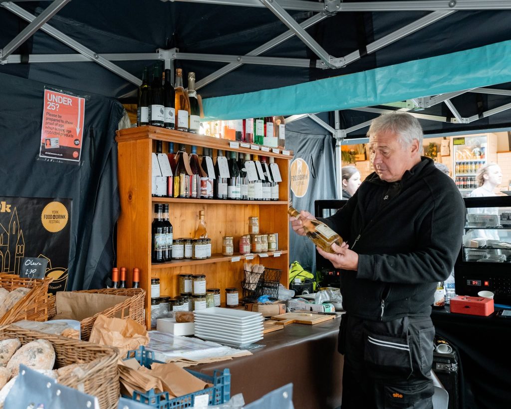 York Food and Drink Festival market trader displaying a bottle of wine