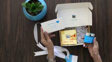 Customer opening a fast delivery box containing gifts and a thank-you card