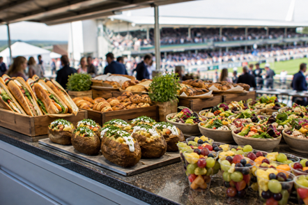 Racecourse food counter with sandwiches salads and fruit