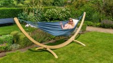 Person relaxing in a hammock in a summer garden