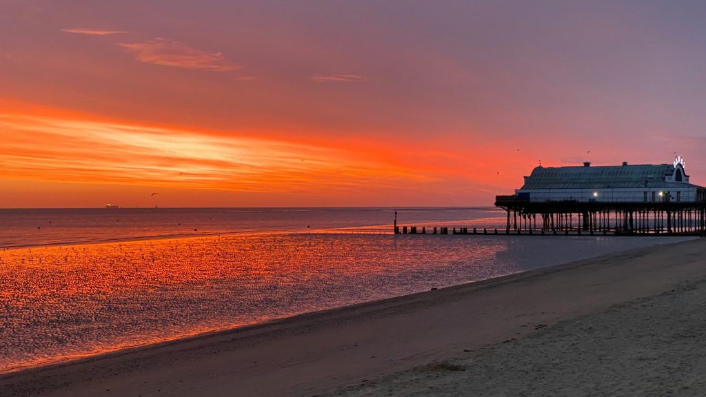 Sunset over Cleethorpes beach and pier near the Humber