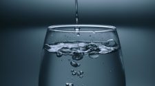Water pouring into a clear drinking glass