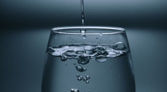 Water pouring into a clear drinking glass