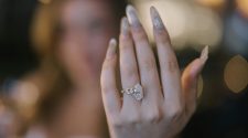 Close-up of a diamond engagement ring on a woman's hand