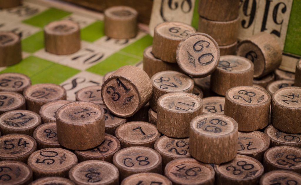 Numbered wooden bingo counters scattered across a bingo card