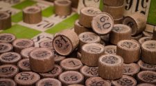 Numbered wooden bingo counters scattered across a bingo card